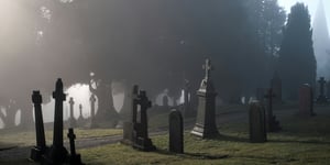 A foggy cemetery; a place to honor the dead.