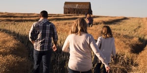  A family walking towards a house or barn.