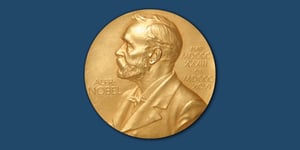 The Nobel Prize medal on a dark blue background.