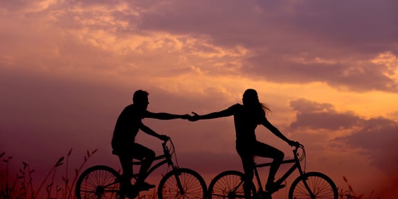 A couple overcoming loneliness by spending time riding bikes together. 