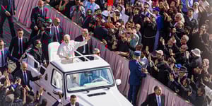 Pope Leo XIV waving from the car. 