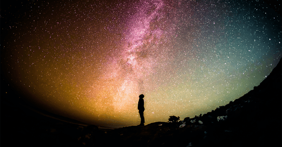 Are we alone in the universe? Person gazing at the night sky